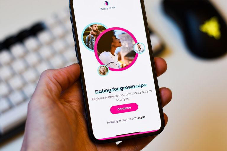 A photo of someone holding a phone with a dating app for grown up relationships