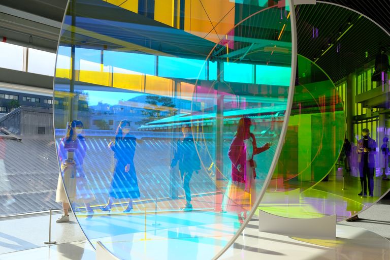 Glass artwork separating museum goers