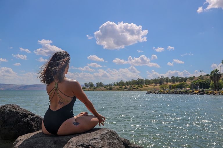 Image subject Person meditating by a serene lake