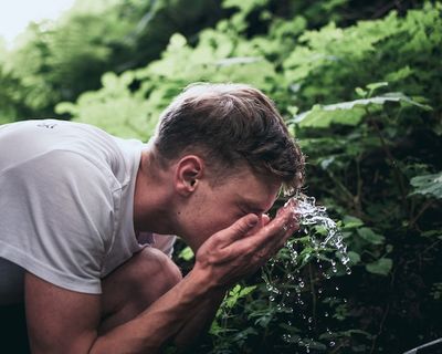 A man washing his face with water